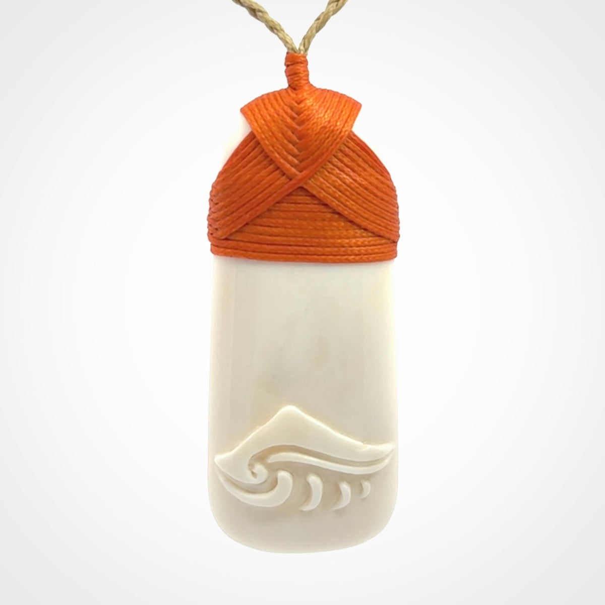 A hand carved bone toki with NZ Pacific logo engraving. Unique hand made jewellery from New Zealand Pacific.