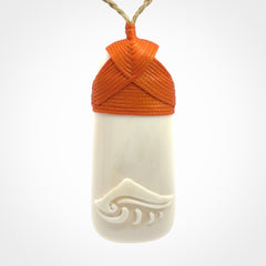 A hand carved bone toki with NZ Pacific logo engraving. Unique hand made jewellery from New Zealand Pacific.