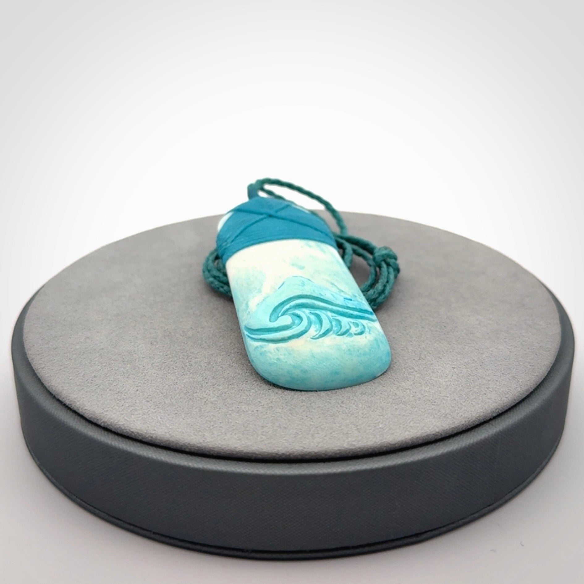 Hand carved bone toki pendant with blue stain
