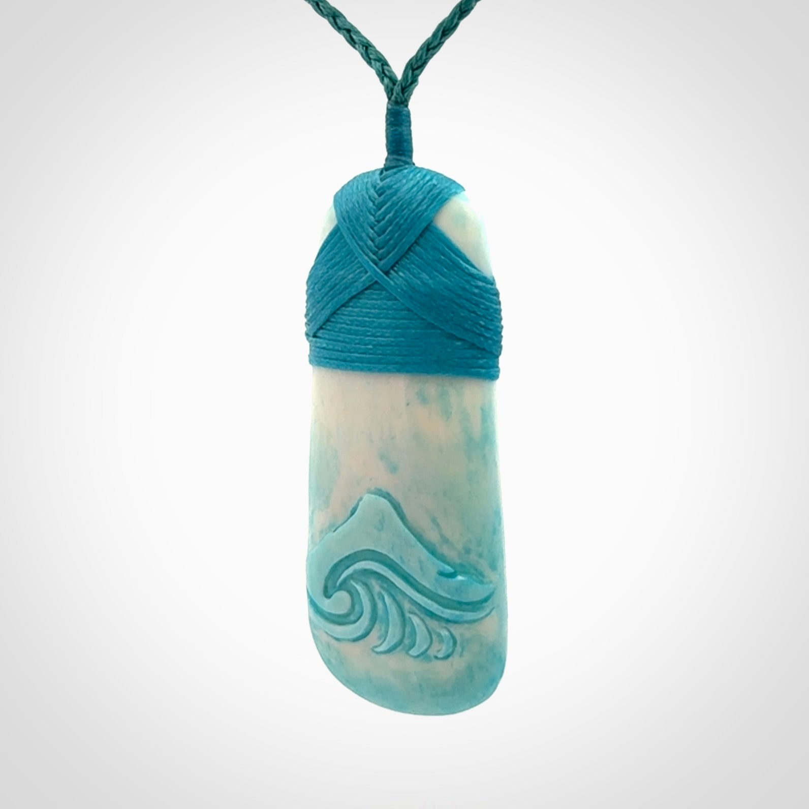 Hand carved bone toki pendant with blue stain