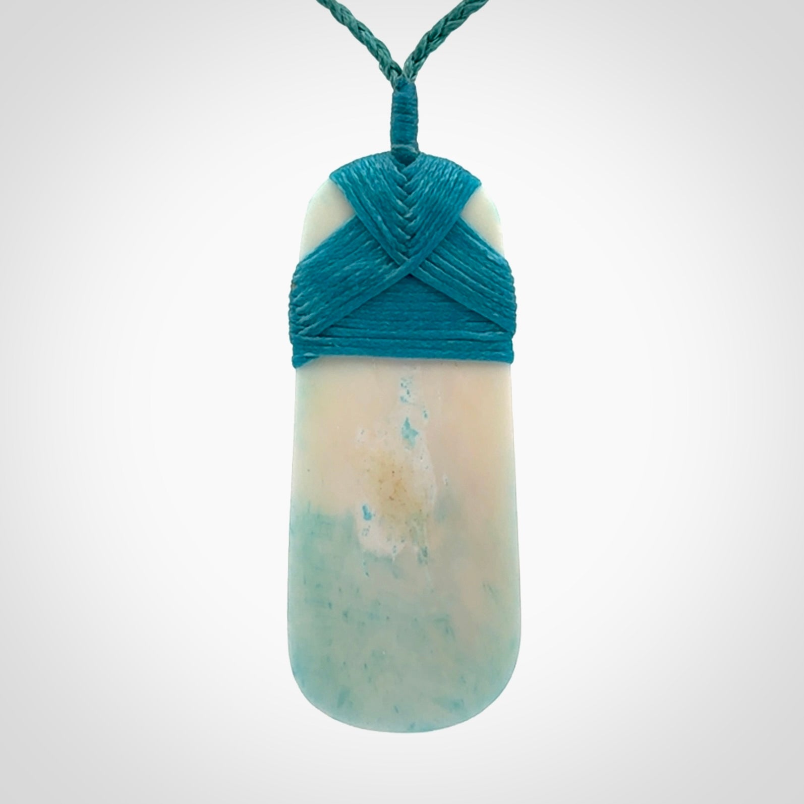 Hand carved bone toki pendant with blue stain