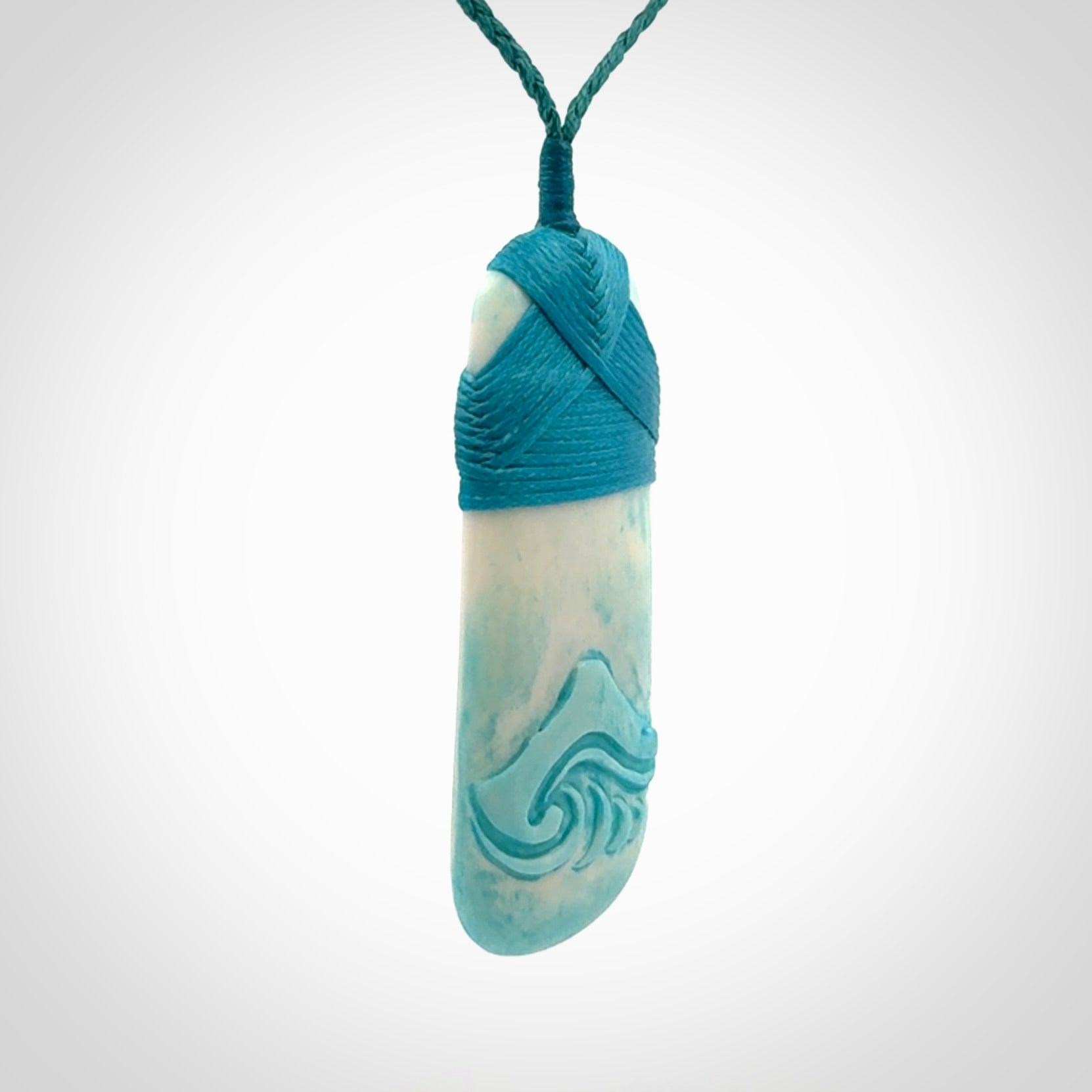 Hand carved bone toki pendant with blue stain