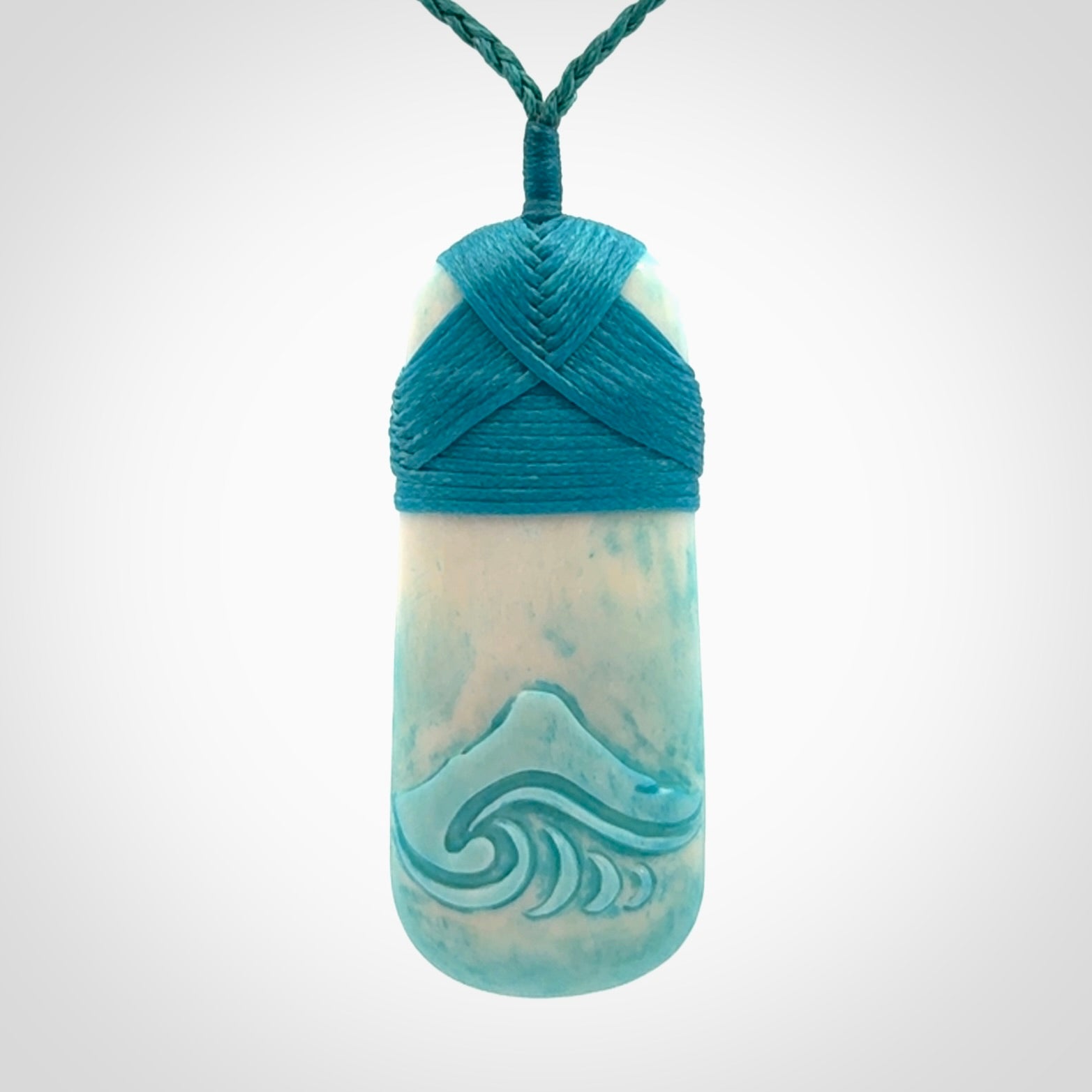 Hand carved bone toki pendant with blue stain