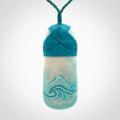 Hand carved bone toki pendant with blue stain