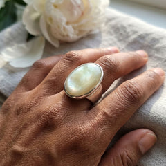 Person wearing mother of pearl and silver ring