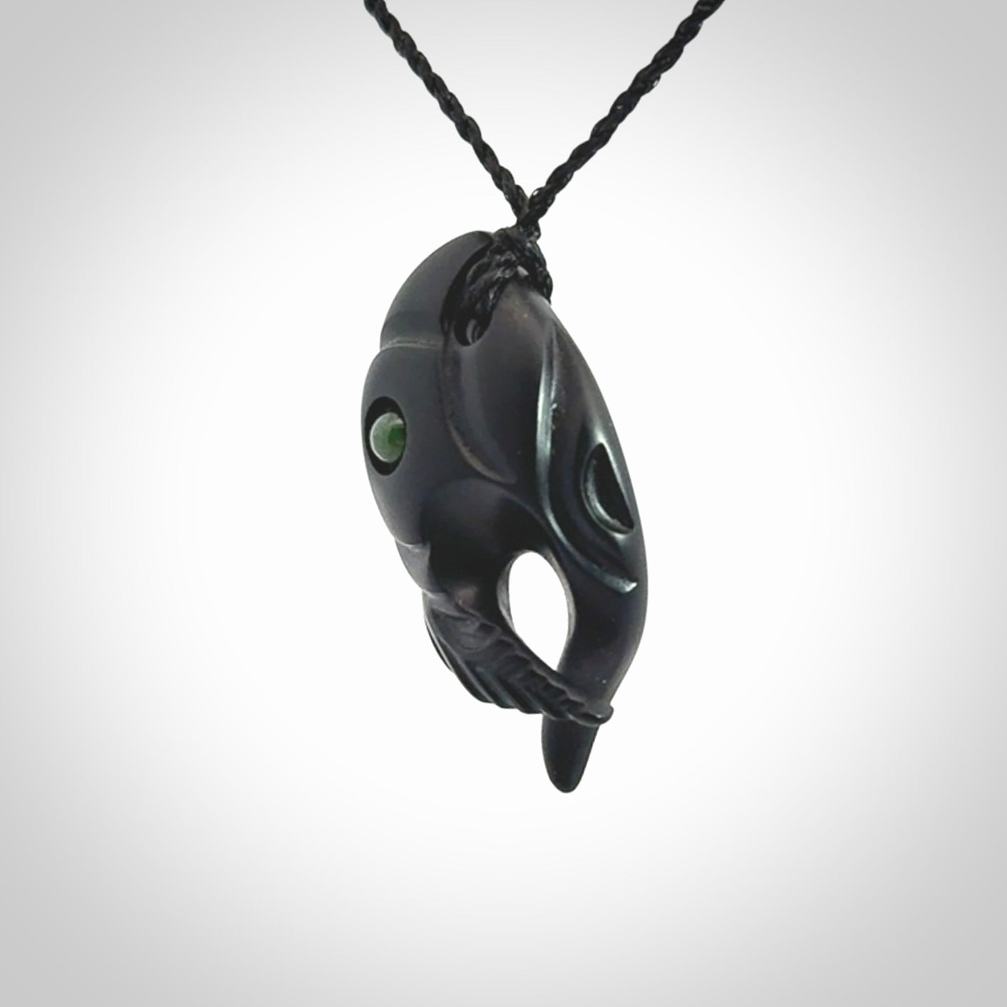This is a hand carved Black Jade bird head pendant with New Zealand Jade insert. This is a smaller sized necklace and is provided with an adjustable black cord.