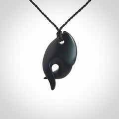 This is a hand carved Black Jade bird head pendant with New Zealand Jade insert. This is a smaller sized necklace and is provided with an adjustable black cord.