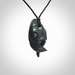 This is a hand carved Black Jade bird head pendant with New Zealand Jade insert. This is a smaller sized necklace and is provided with an adjustable black cord.