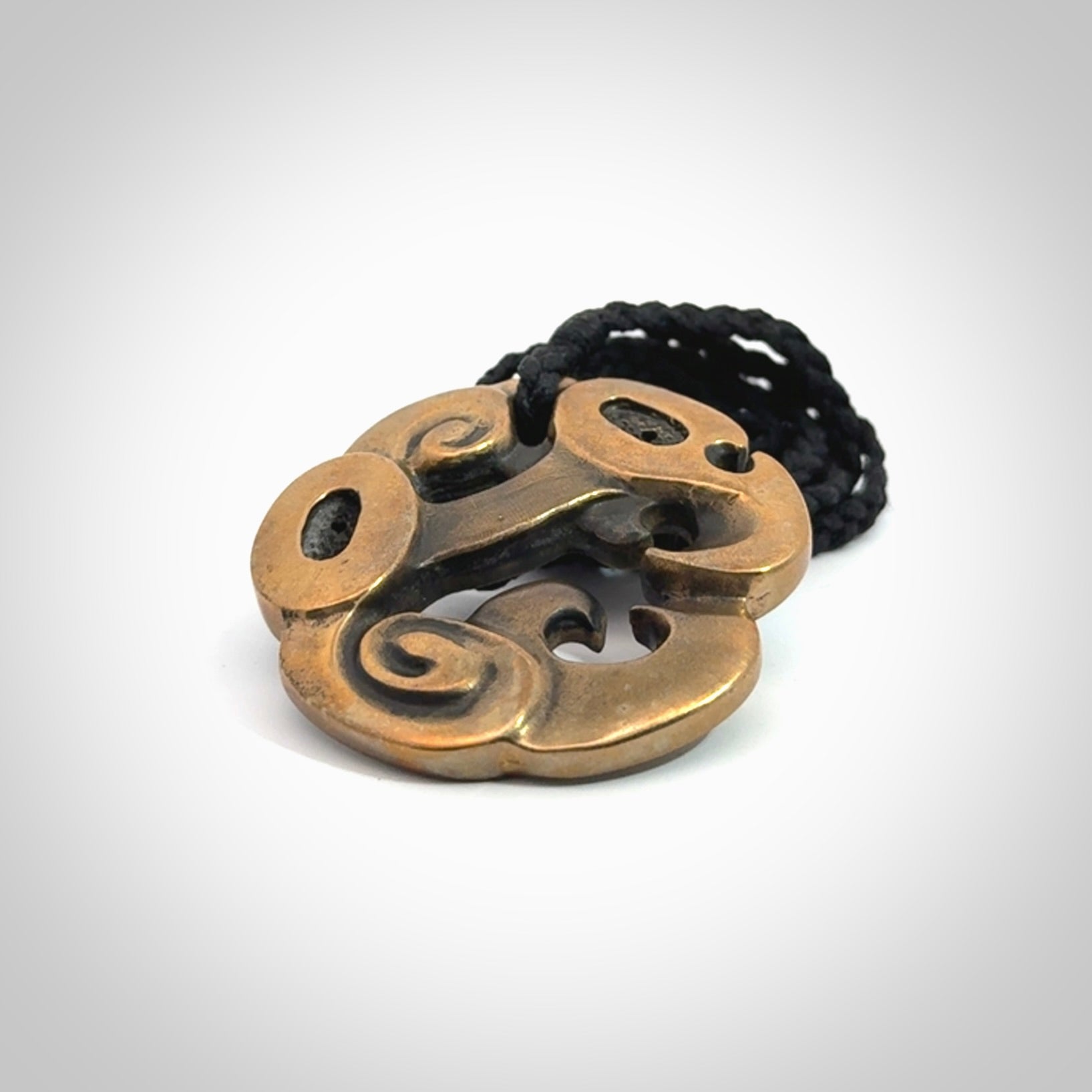 A beautiful hand made, bronze manaia pendant.