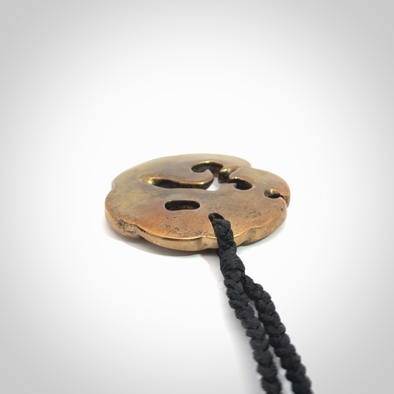 A beautiful hand made, bronze manaia pendant.