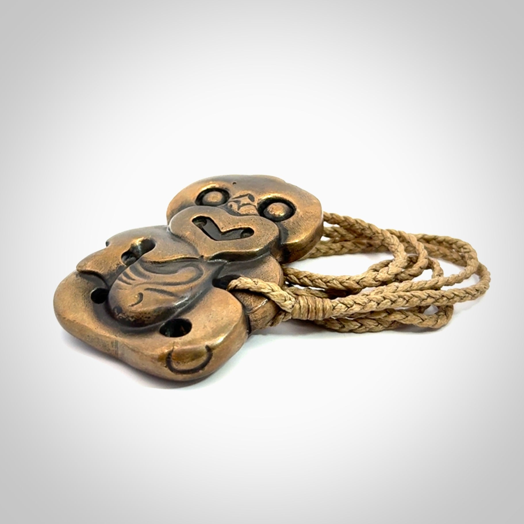 A beautiful hand made, bronze tiki pendant.