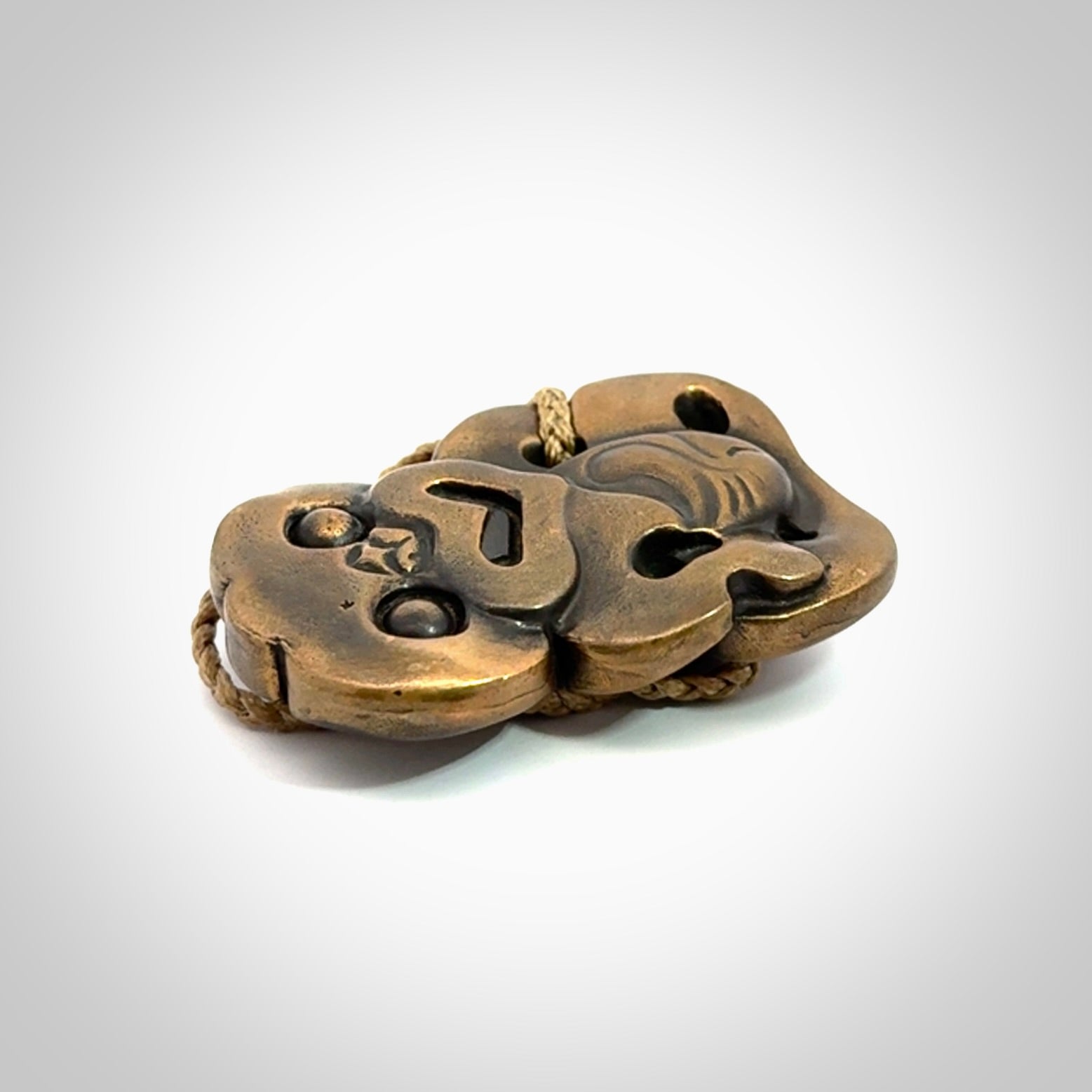 A beautiful hand made, bronze tiki pendant.