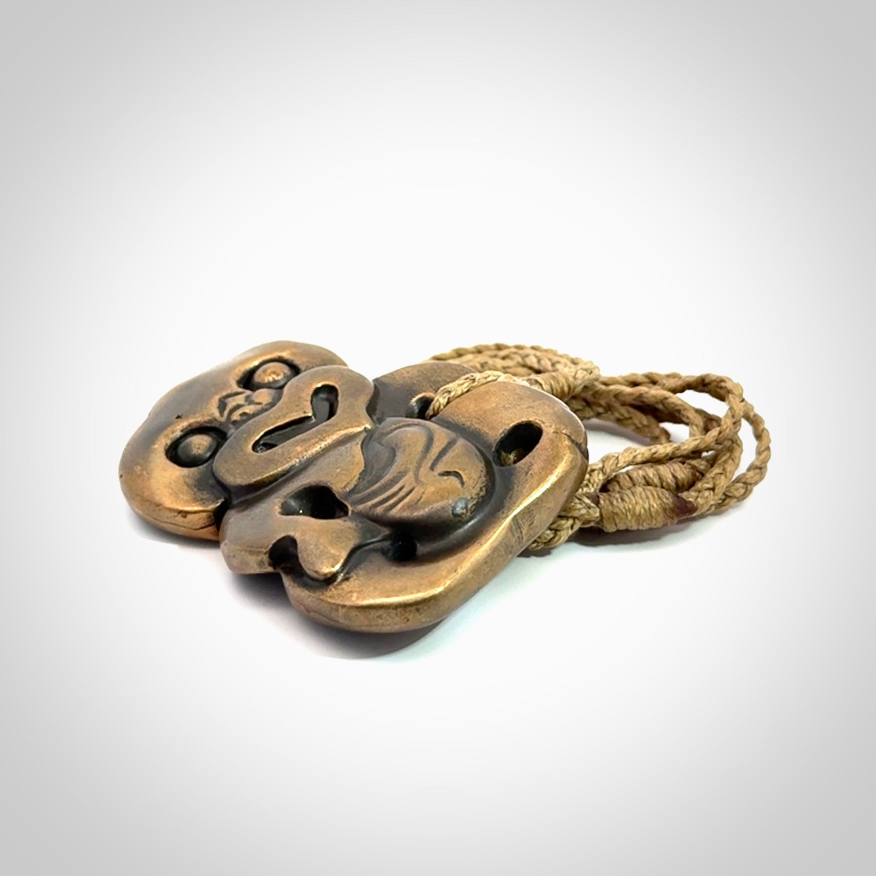 A beautiful hand made, bronze tiki pendant.