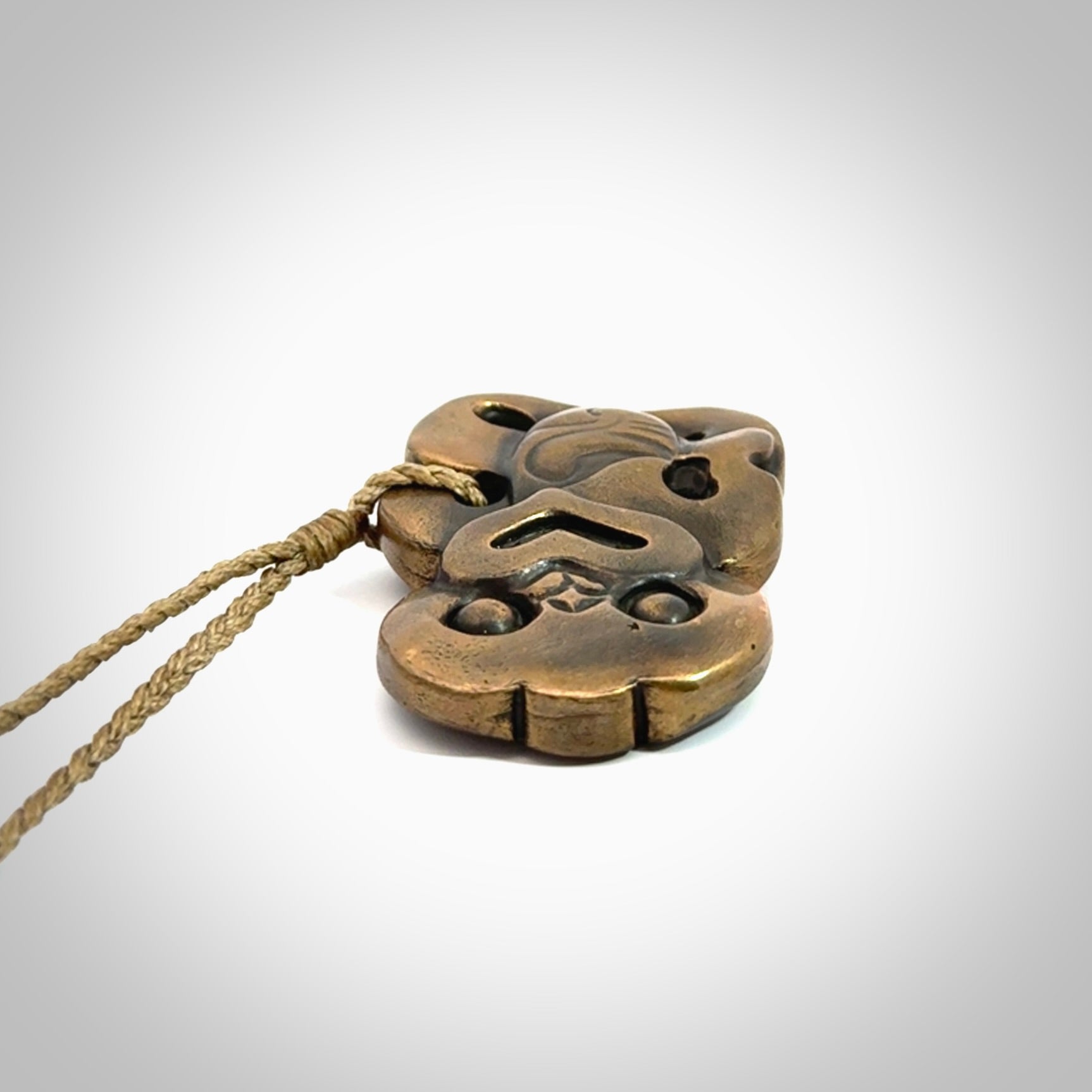 A beautiful hand made, bronze tiki pendant.