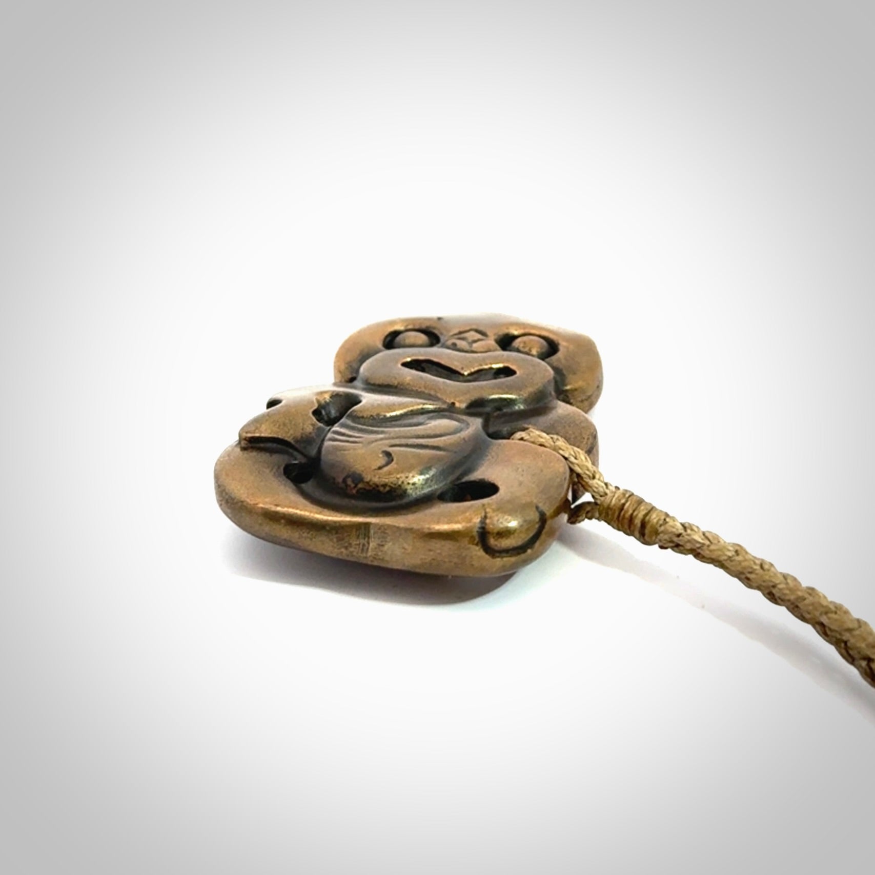 A beautiful hand made, bronze tiki pendant.
