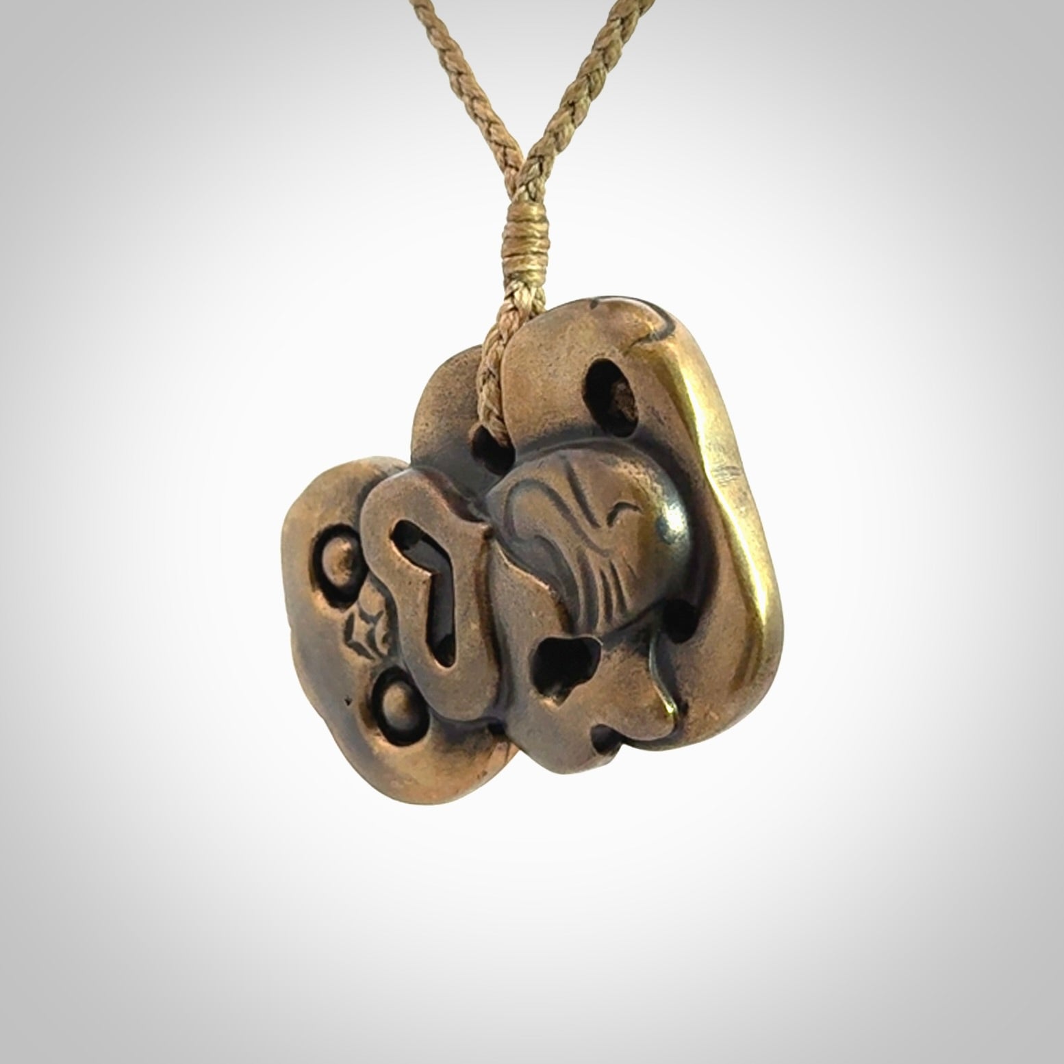 A beautiful hand made, bronze tiki pendant.