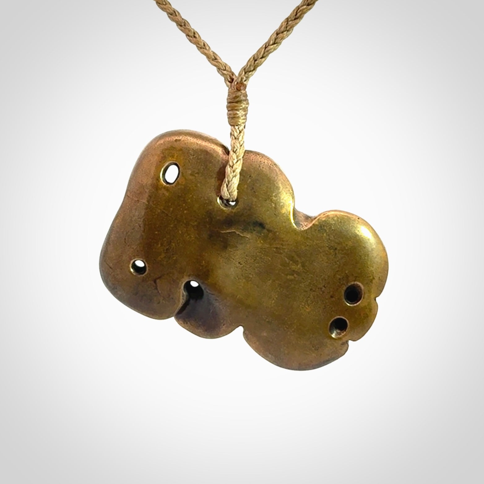 A beautiful hand made, bronze tiki pendant.