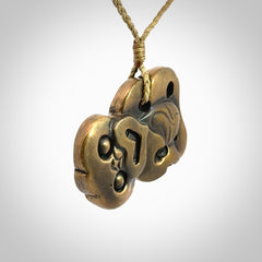 A beautiful hand made, bronze tiki pendant.