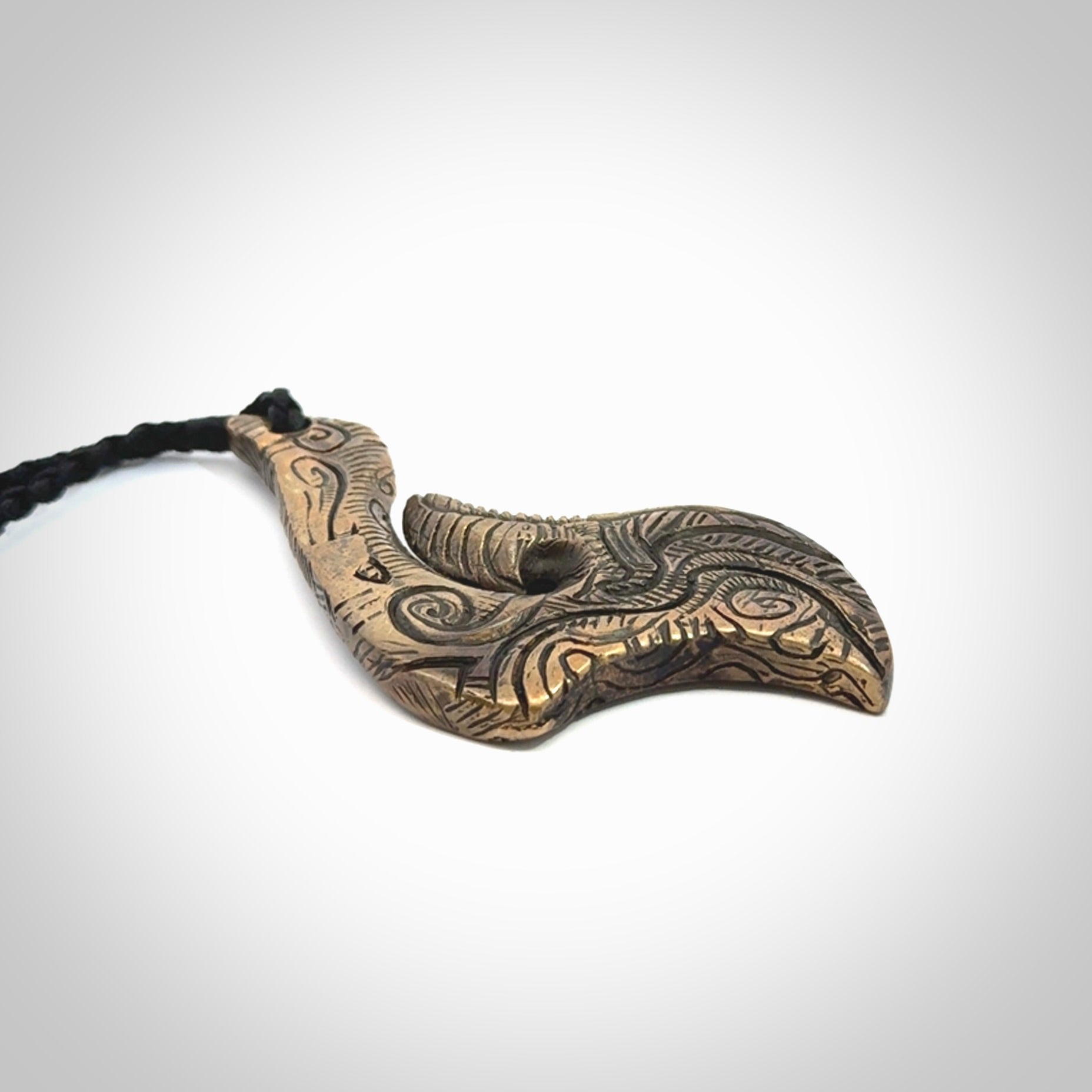 A beautiful hand made, bronze matau pendant.