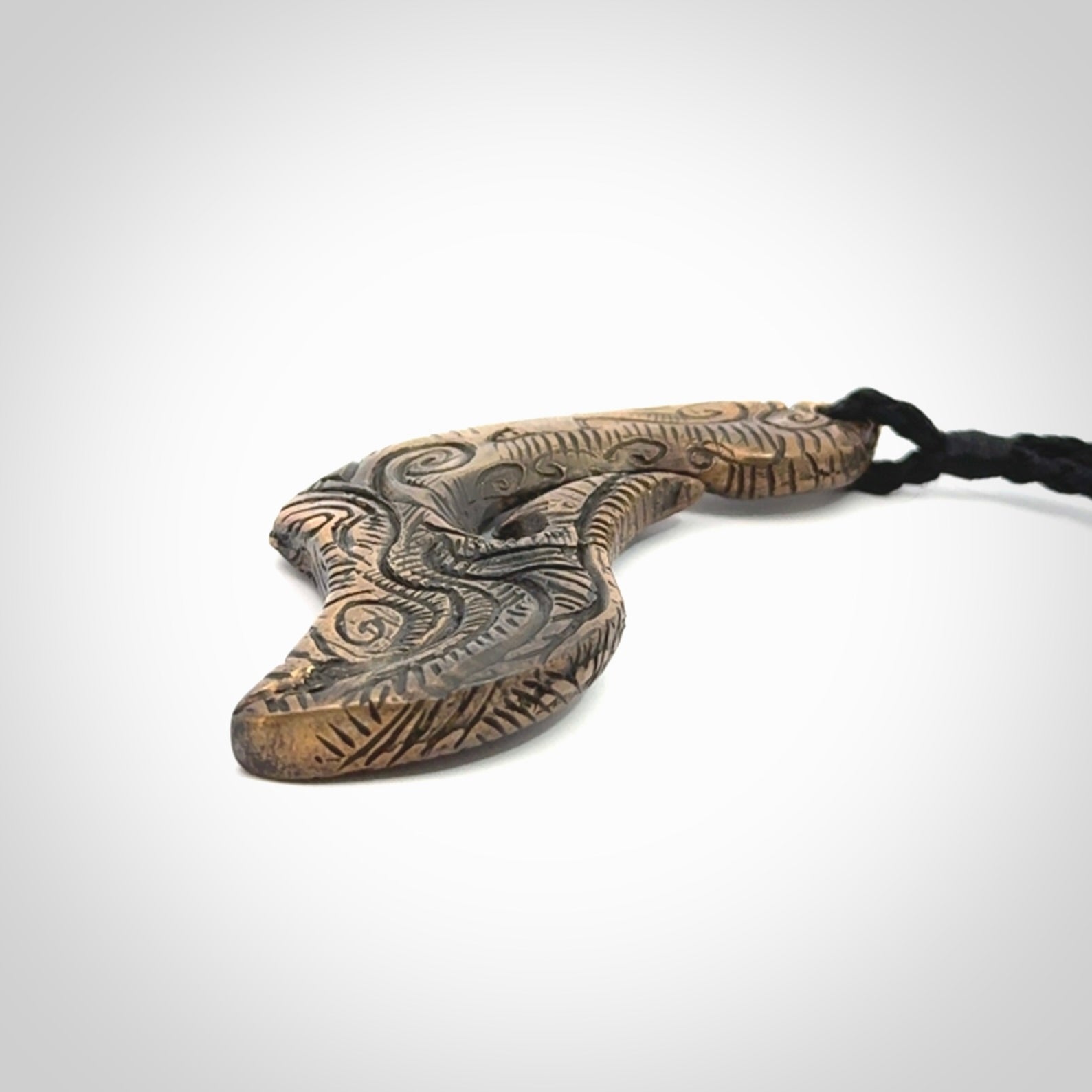 A beautiful hand made, bronze matau pendant.