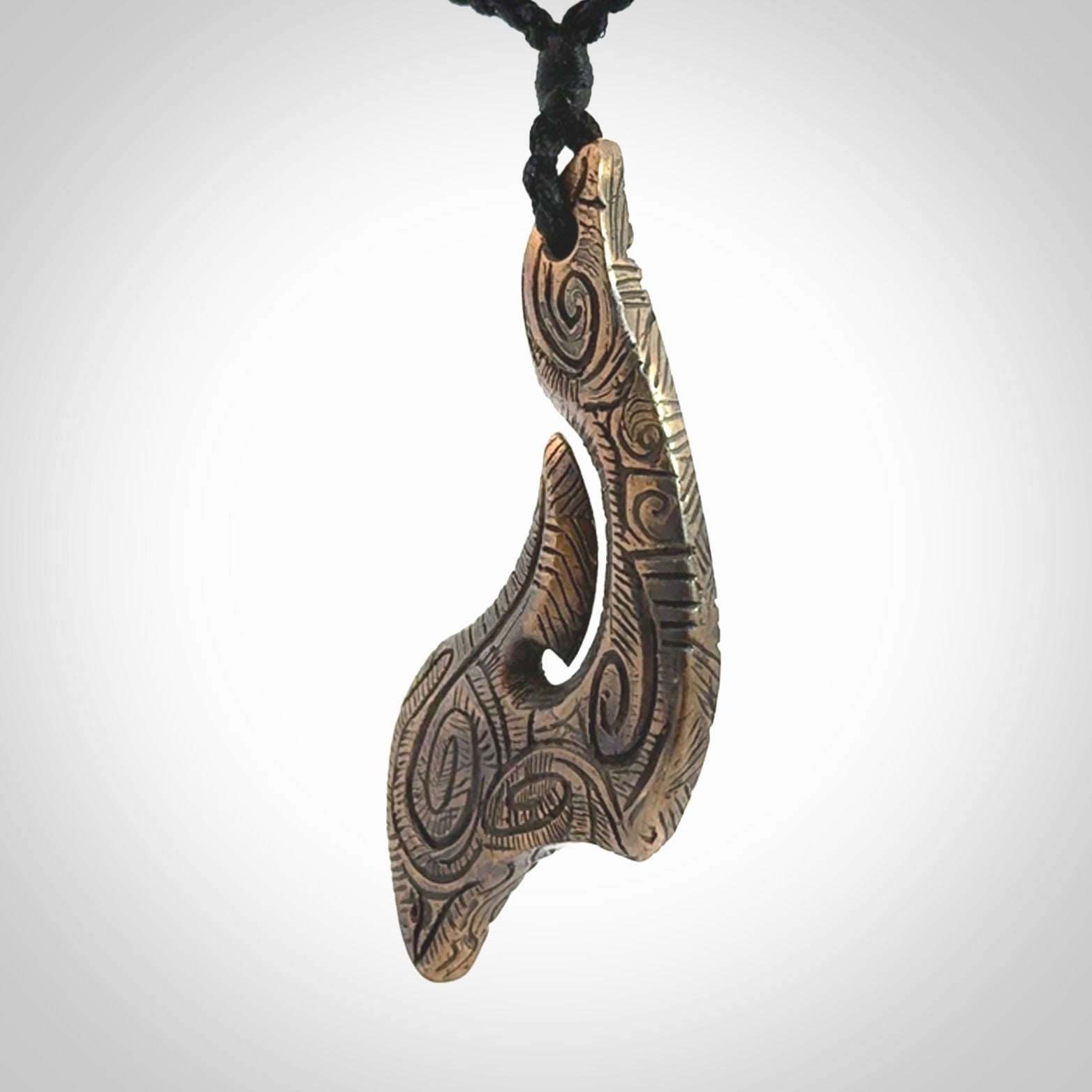 A beautiful hand made, bronze matau pendant.