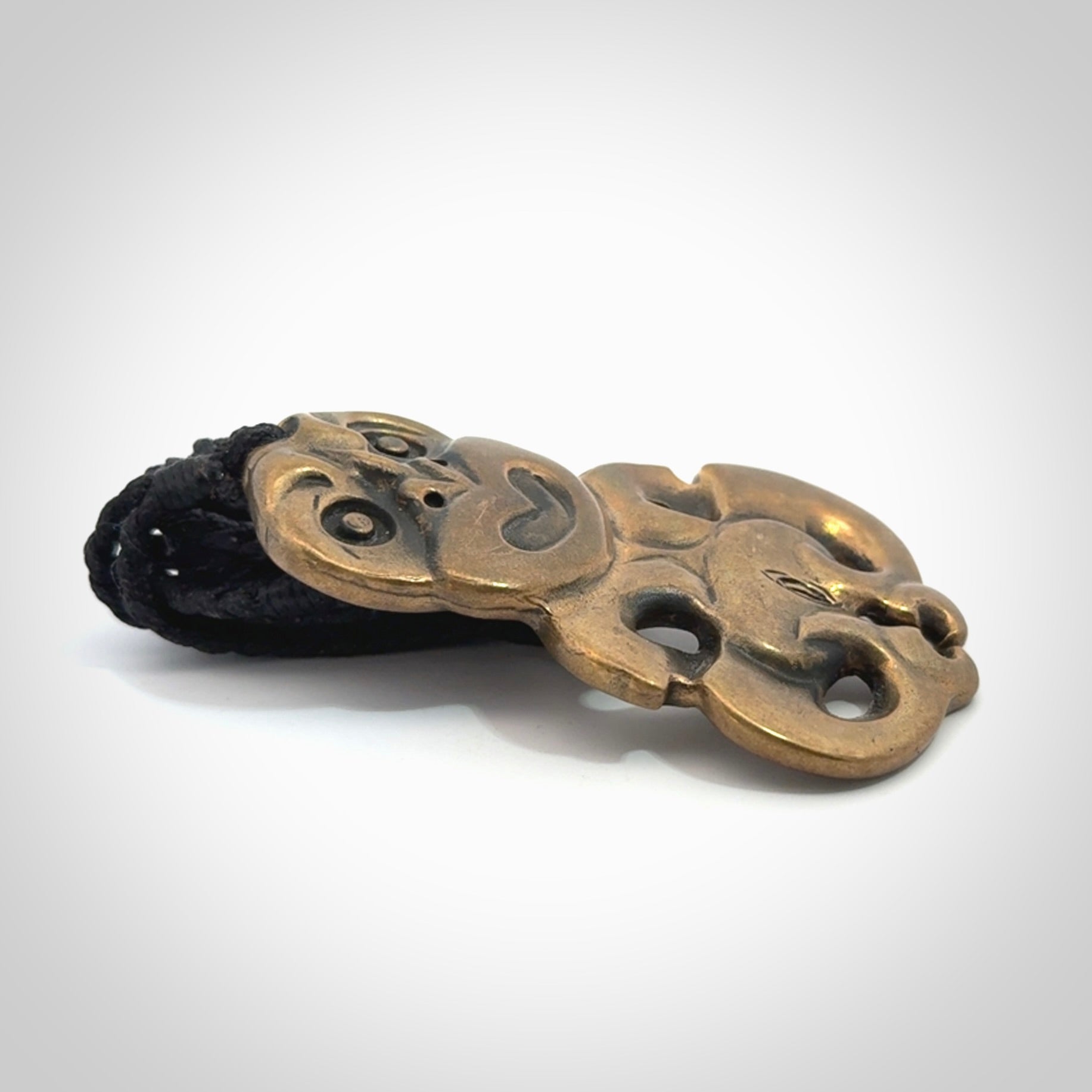 A beautiful hand made, bronze tiki pendant.