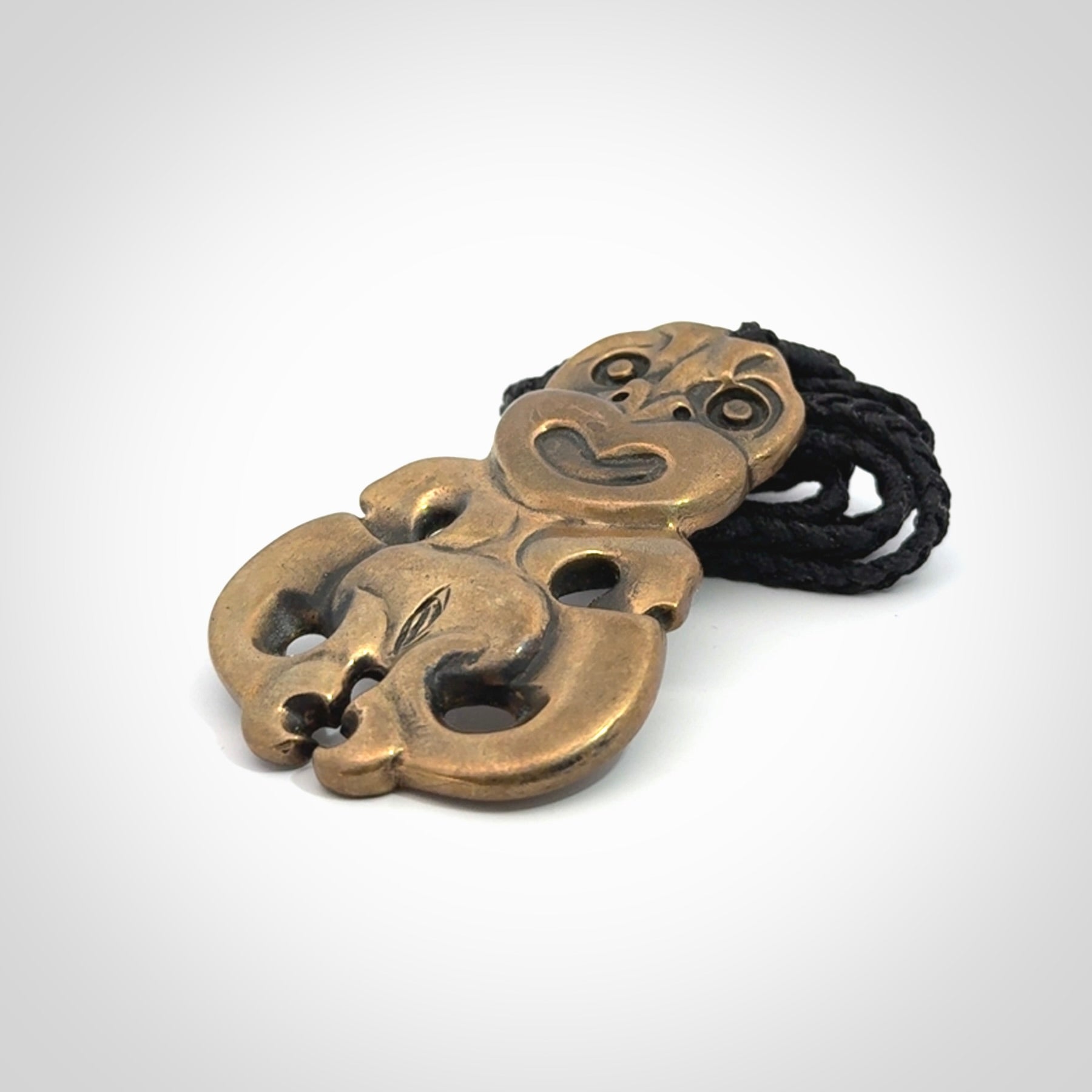 A beautiful hand made, bronze tiki pendant.