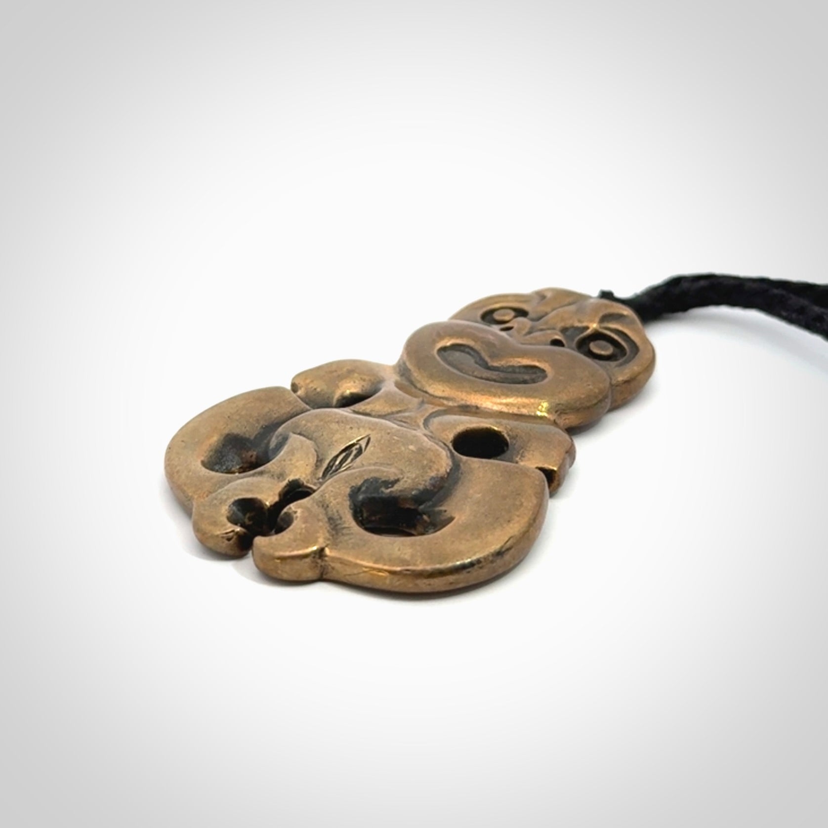 A beautiful hand made, bronze tiki pendant.