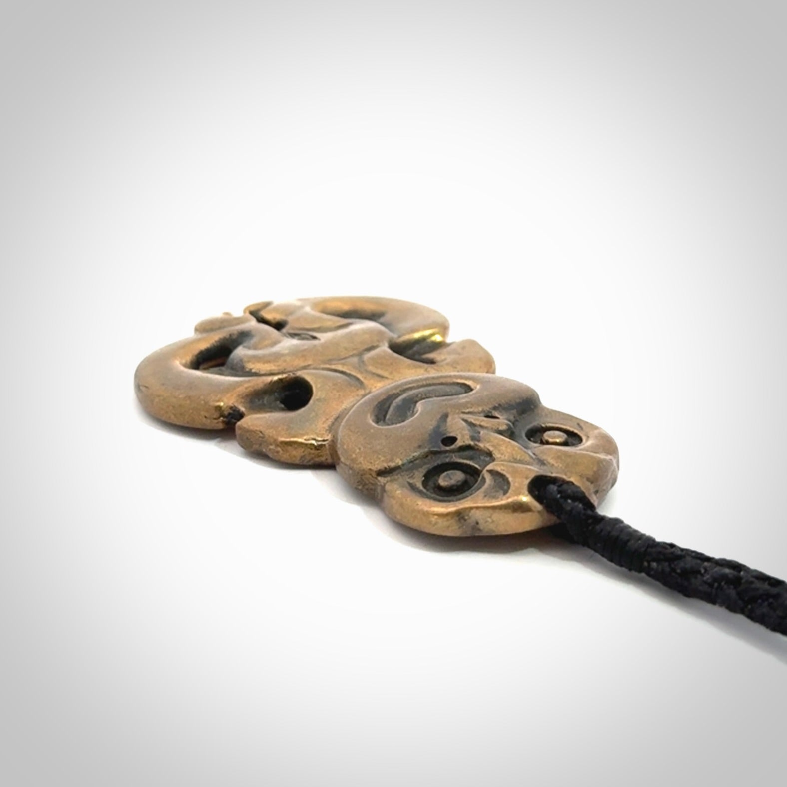 A beautiful hand made, bronze tiki pendant.