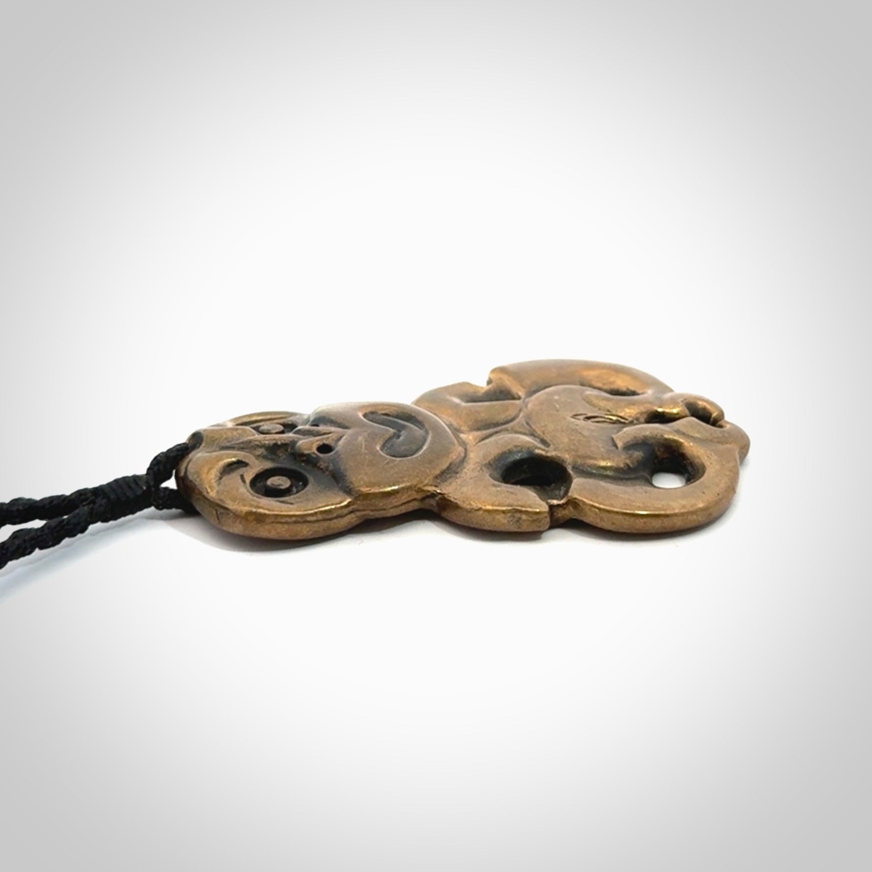 A beautiful hand made, bronze tiki pendant.