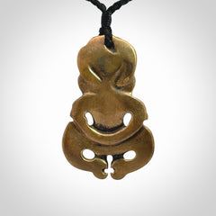 A beautiful hand made, bronze tiki pendant.