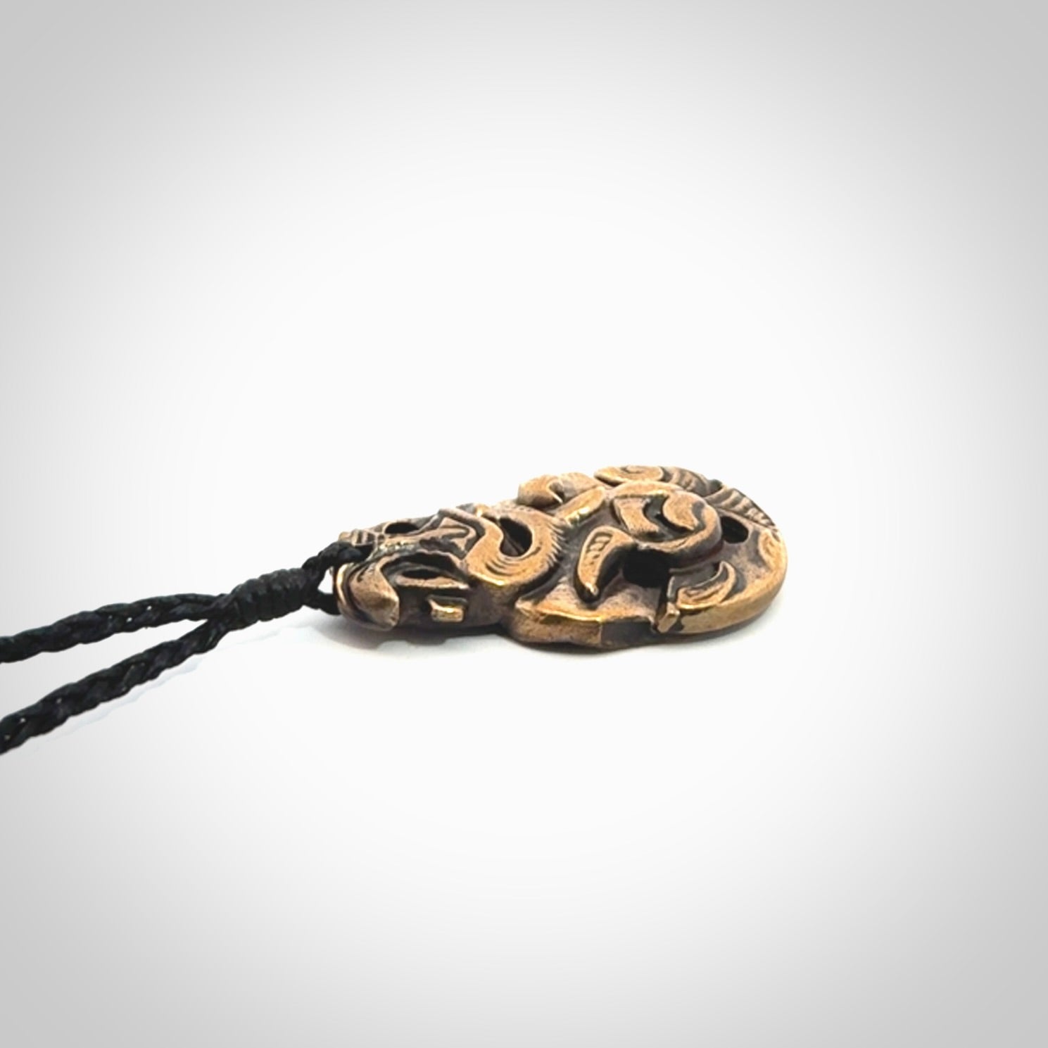 A beautiful hand made, bronze tiki pendant.