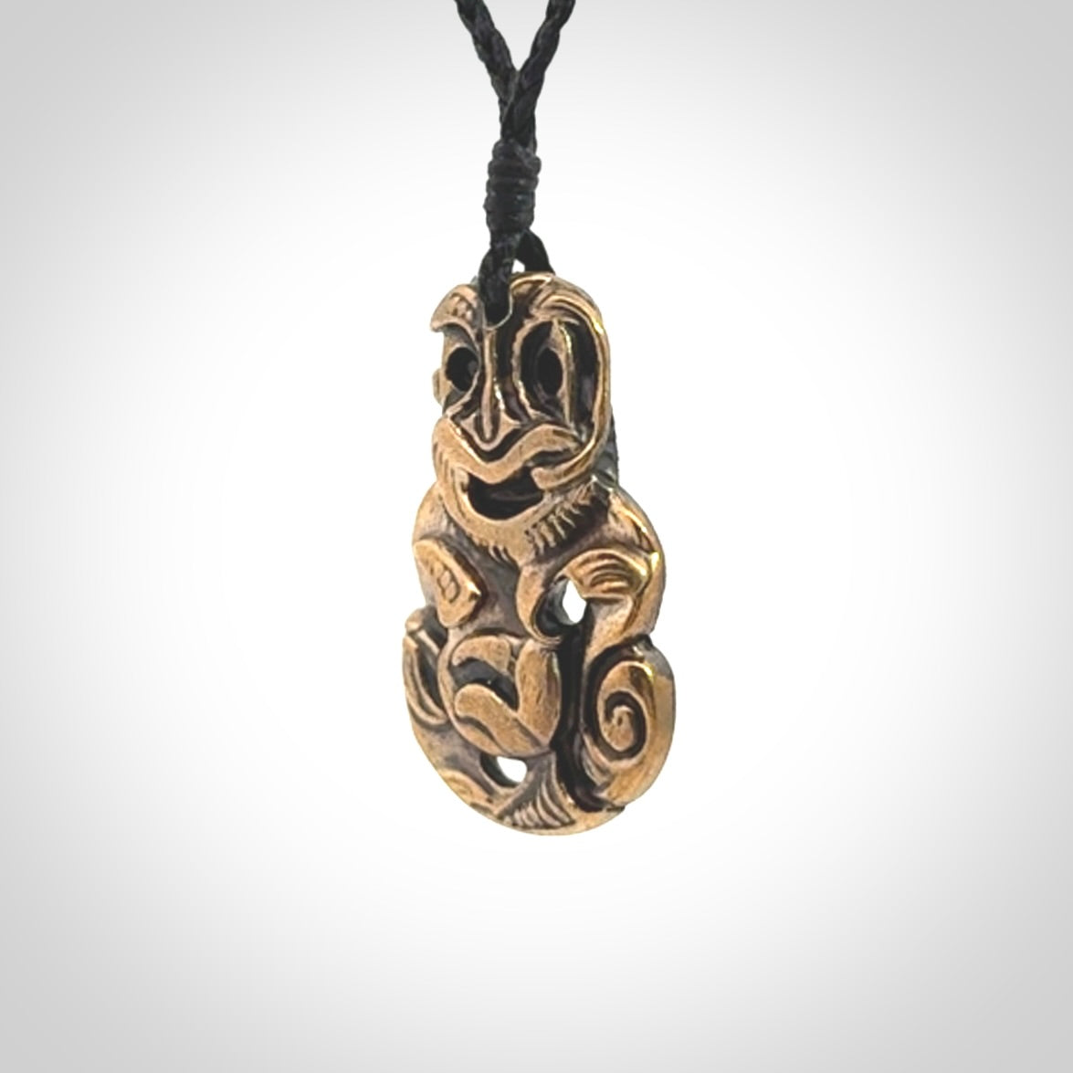 A beautiful hand made, bronze tiki pendant.