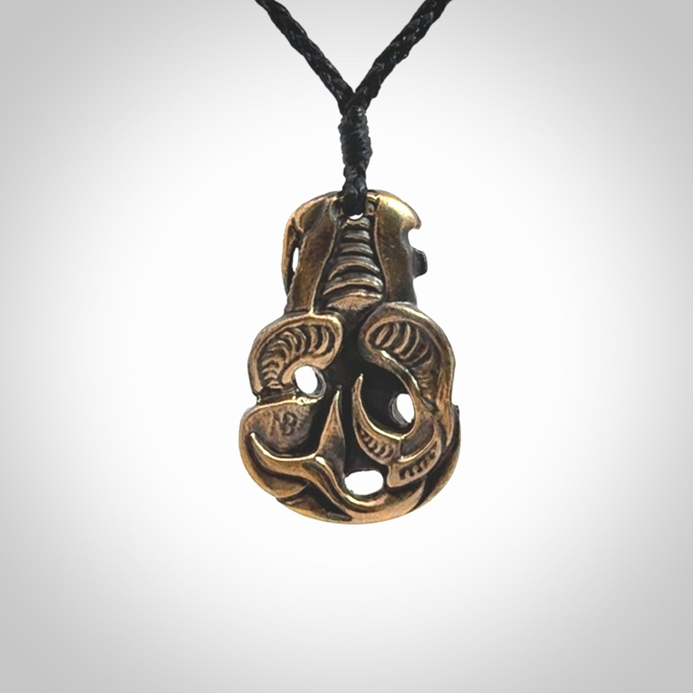A beautiful hand made, bronze tiki pendant.