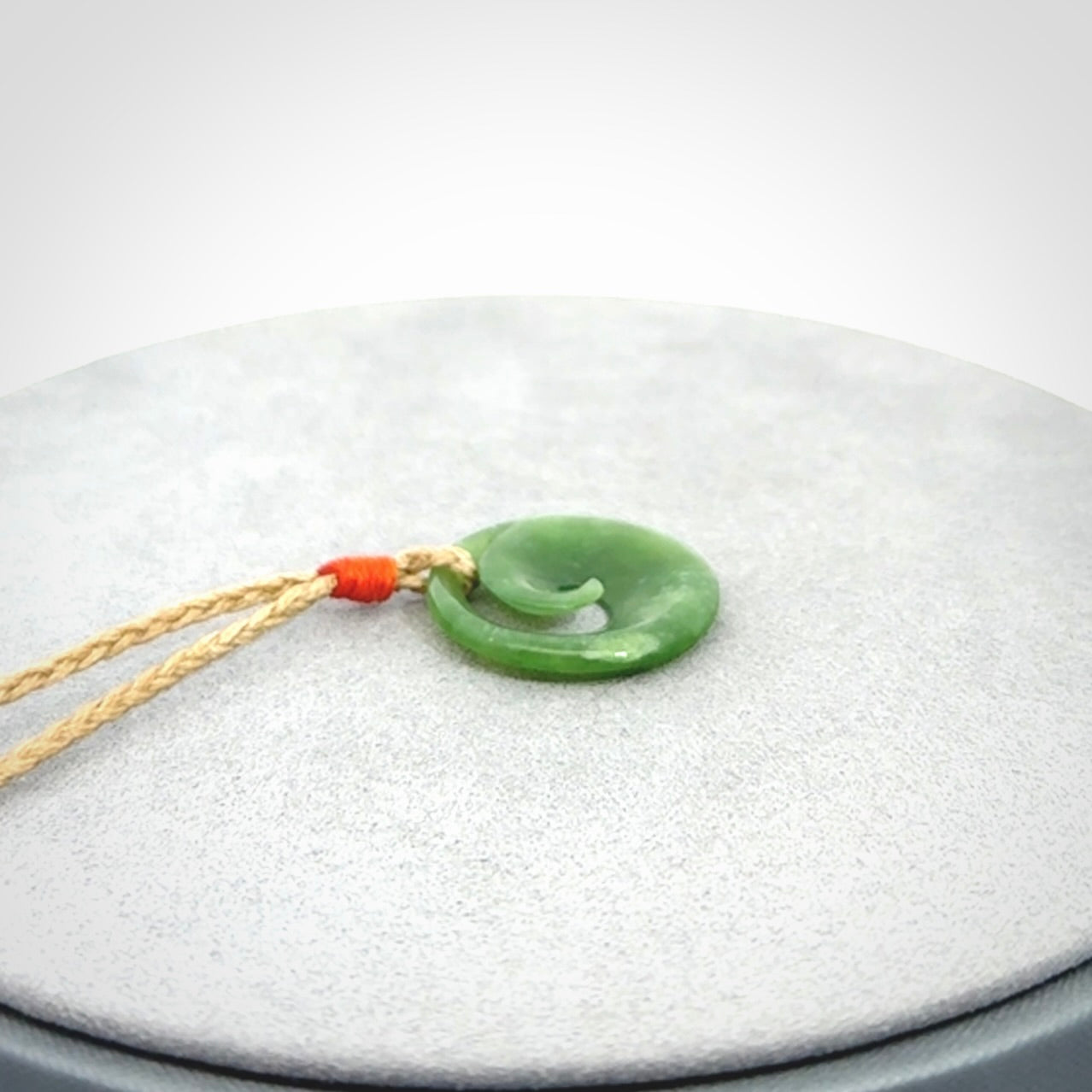 This little pendant is a beautifully carved, small jade koru pendant. Hand Carved for NZ Pacific by Graeme Wylie. Jade jewelry for sale online exclusively with NZ Pacific.
