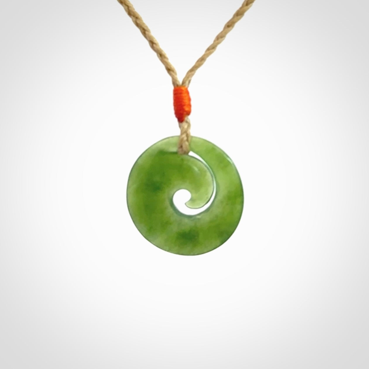 This little pendant is a beautifully carved, small jade koru pendant. Hand Carved for NZ Pacific by Graeme Wylie. Jade jewelry for sale online exclusively with NZ Pacific.