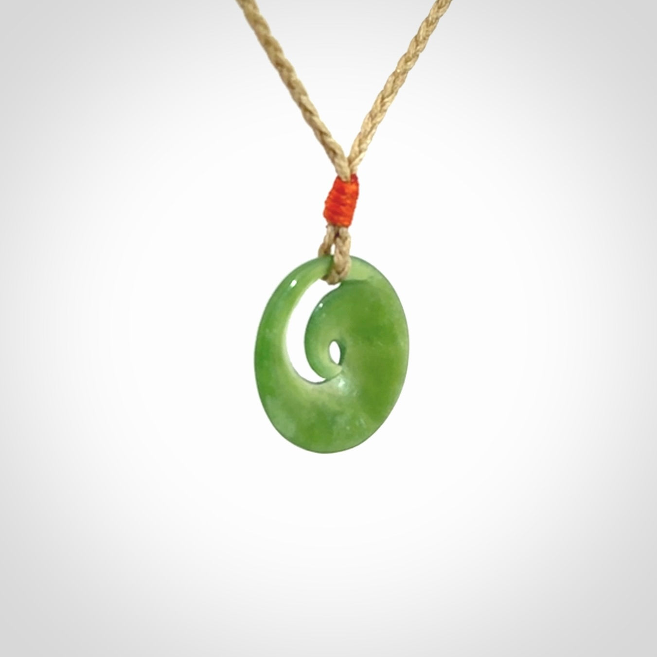 This little pendant is a beautifully carved, small jade koru pendant. Hand Carved for NZ Pacific by Graeme Wylie. Jade jewelry for sale online exclusively with NZ Pacific.
