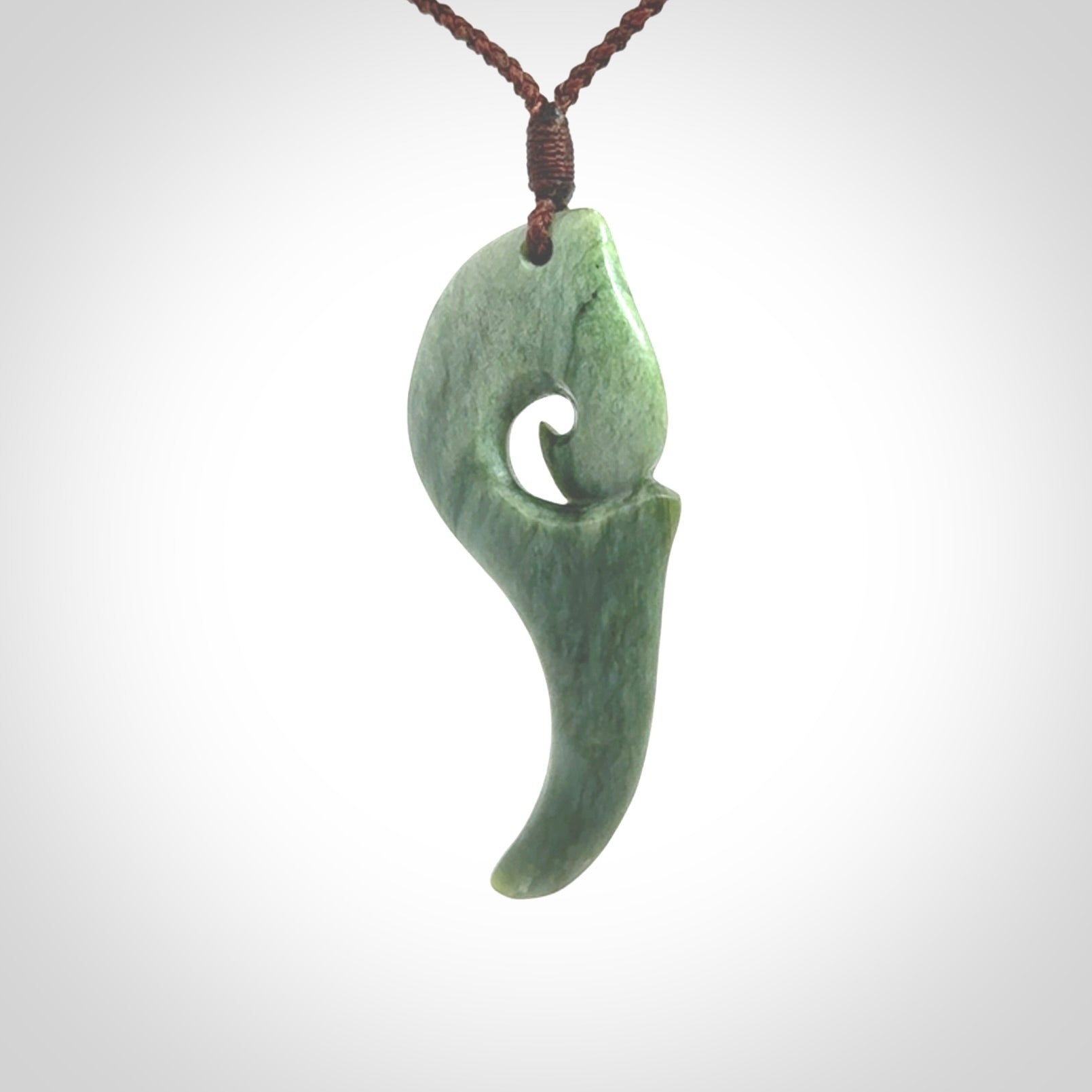 Hand carved huia bird skull made from New Zealand Marsden Jade pendant. Carved for NZ Pacific by Kyohei Noguchi. This is a contemporary piece of jewellery that is carved with intricate detail and clearly shows a beautiful bird skull.