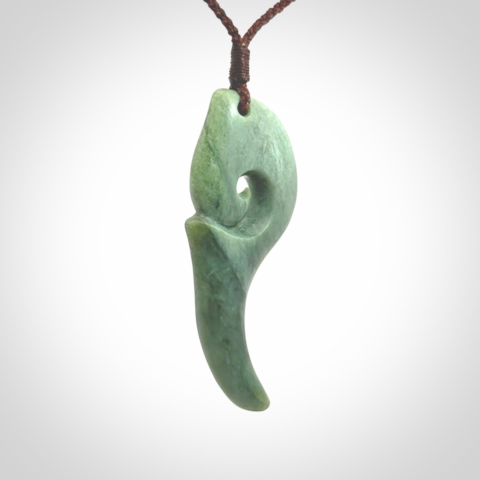 Hand carved huia bird skull made from New Zealand Marsden Jade pendant. Carved for NZ Pacific by Kyohei Noguchi. This is a contemporary piece of jewellery that is carved with intricate detail and clearly shows a beautiful bird skull.