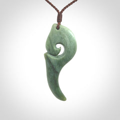 Hand carved huia bird skull made from New Zealand Marsden Jade pendant. Carved for NZ Pacific by Kyohei Noguchi. This is a contemporary piece of jewellery that is carved with intricate detail and clearly shows a beautiful bird skull.