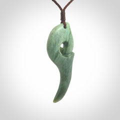 Hand carved huia bird skull made from New Zealand Marsden Jade pendant. Carved for NZ Pacific by Kyohei Noguchi. This is a contemporary piece of jewellery that is carved with intricate detail and clearly shows a beautiful bird skull.