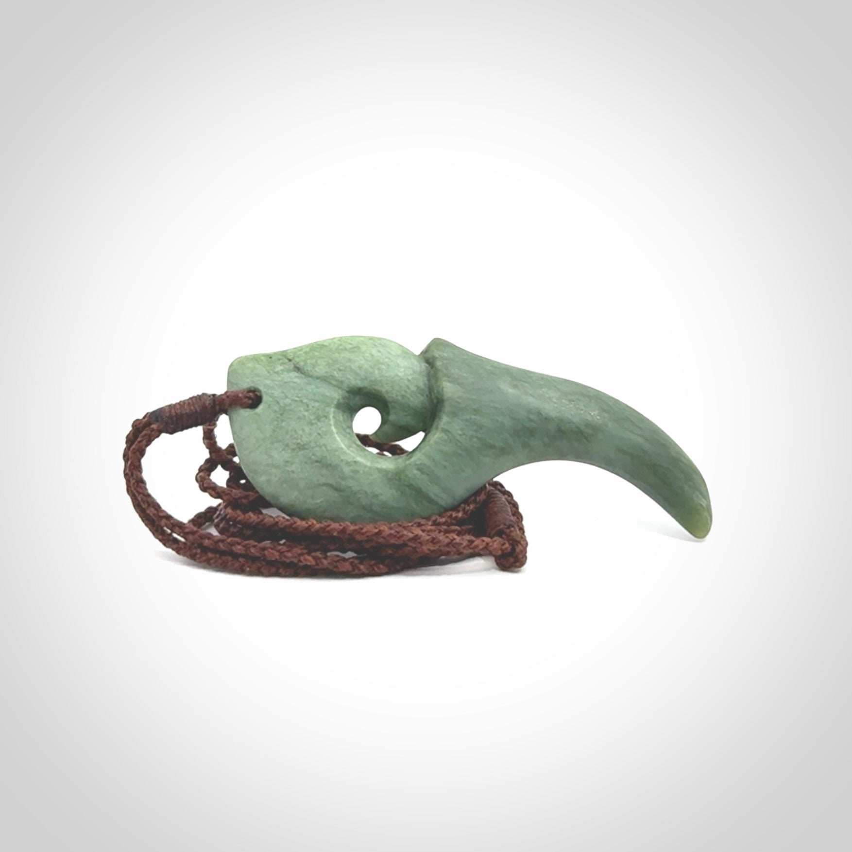 Hand carved huia bird skull made from New Zealand Marsden Jade pendant. Carved for NZ Pacific by Kyohei Noguchi. This is a contemporary piece of jewellery that is carved with intricate detail and clearly shows a beautiful bird skull.