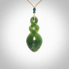 Hand carved New Zealand jade twist pendant. Carved in New Zealand by NZ Pacific. Unique double twist jewellery for sale online. Provided with an adjustable tan cord.