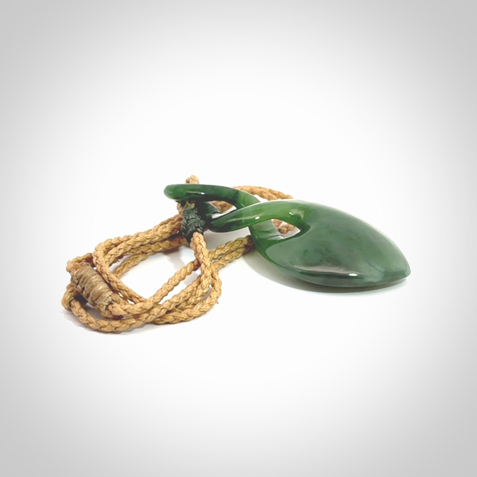 Hand carved New Zealand jade twist pendant. Carved in New Zealand by NZ Pacific. Unique double twist jewellery for sale online. Provided with an adjustable tan cord.