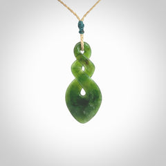 Hand carved New Zealand jade twist pendant. Carved in New Zealand by NZ Pacific. Unique double twist jewellery for sale online. Provided with an adjustable tan cord.
