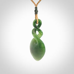 Hand carved New Zealand jade twist pendant. Carved in New Zealand by NZ Pacific. Unique double twist jewellery for sale online. Provided with an adjustable tan cord.