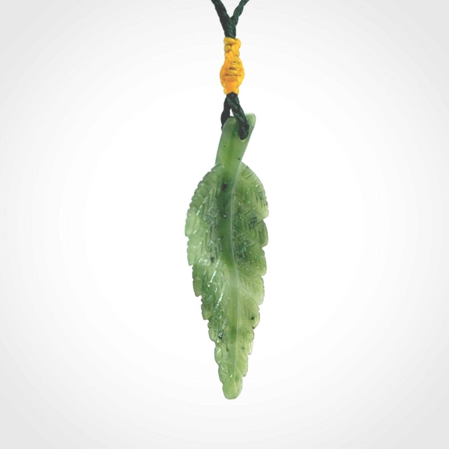 A delicate green jade fern leaf pendant with an adjustable neck cord. Green stone fern leaf necklace with adjustable cord. Delivery included.