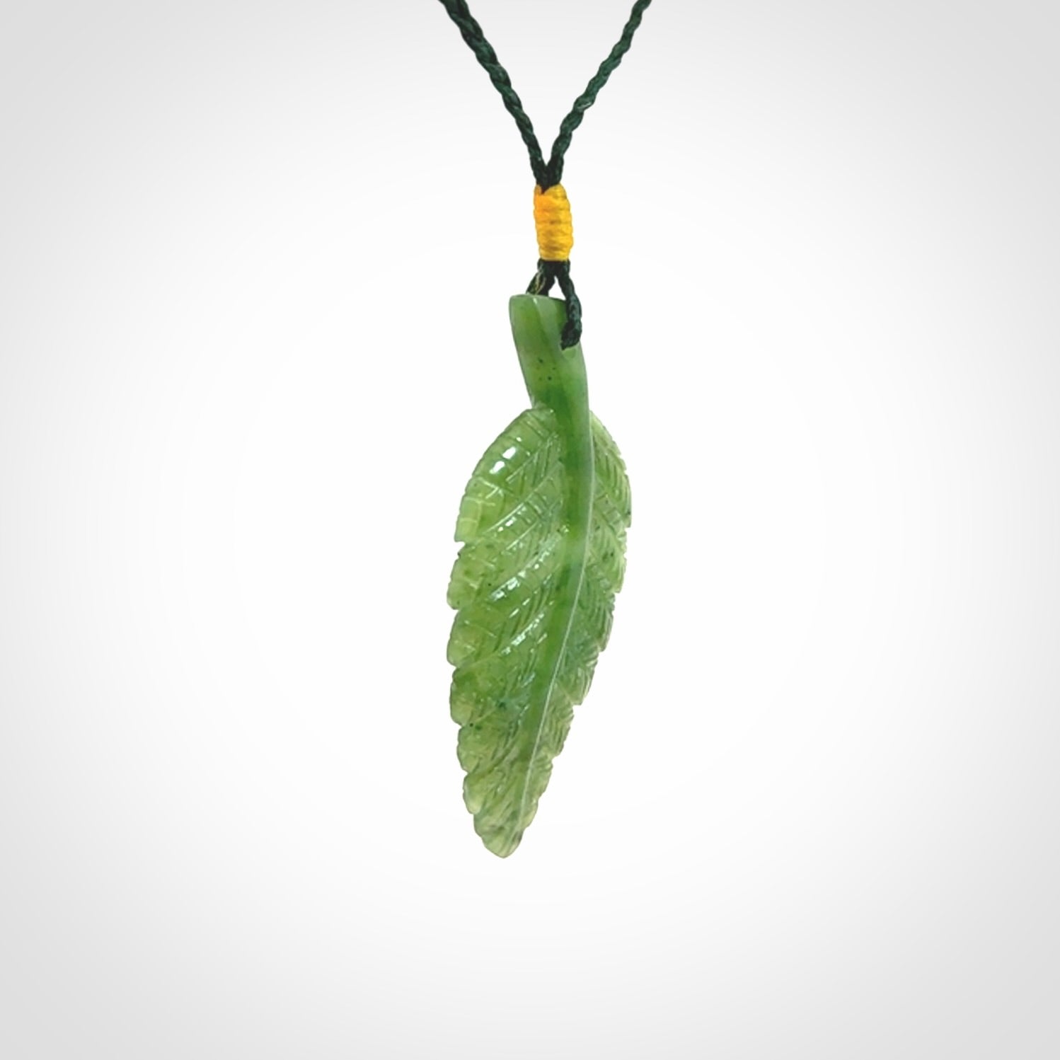 A delicate green jade fern leaf pendant with an adjustable neck cord. Green stone fern leaf necklace with adjustable cord. Delivery included.