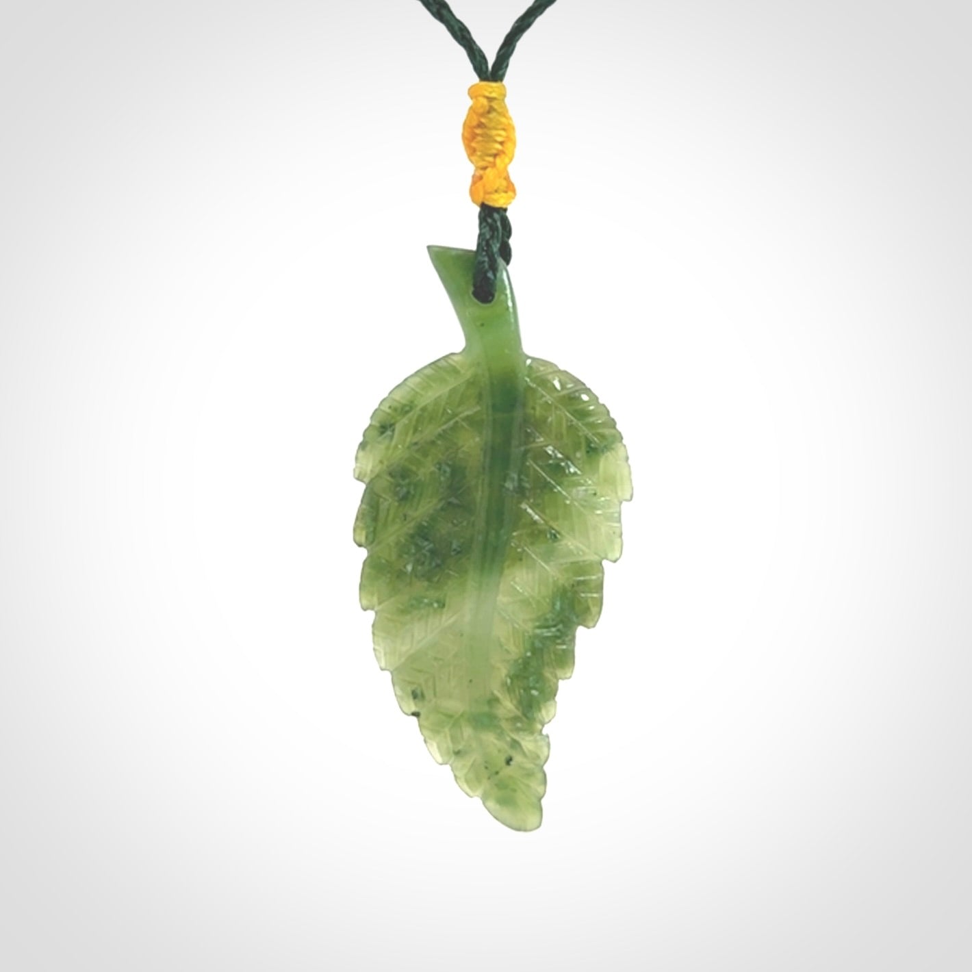 A delicate green jade fern leaf pendant with an adjustable neck cord. Green stone fern leaf necklace with adjustable cord. Delivery included.