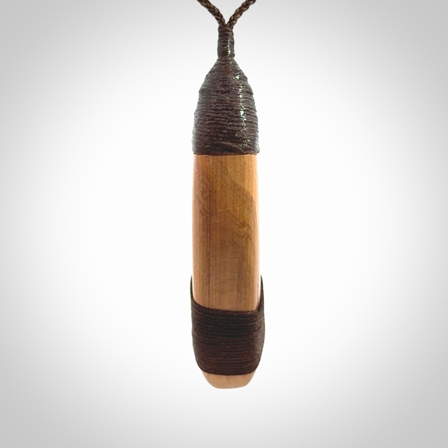 This picture shows a large matau, hook called a pā kahawai. It is carved from bone,  wood, and paua shell. One only, free shipping worldwide. Provided with an adjustable brown cord. Stunning work of Art to Wear by Andrew Doughty.